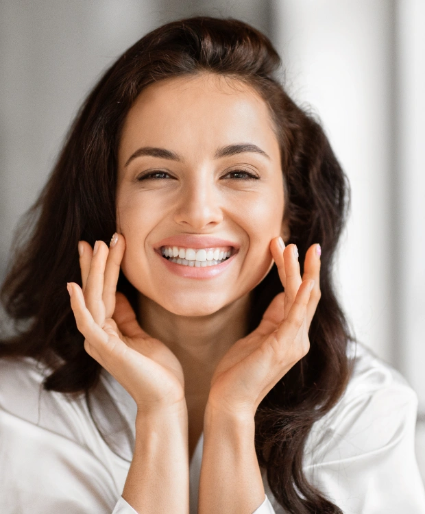 Woman smiling after cosmetic dental treatment